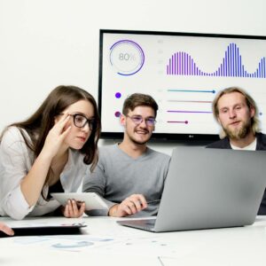 Man and Woman Sitting at Table With Macbook