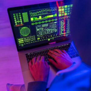 Person Using Macbook Pro on Pink Table