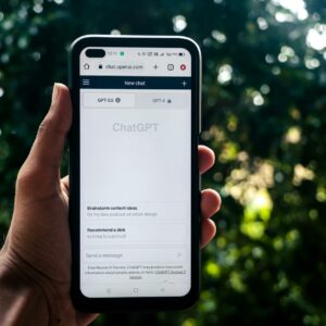 Webpage of ChatGPT, a prototype AI chatbot, is seen on the website of OpenAI, on a smartphone. Examples, capabilities, and limitations are shown.